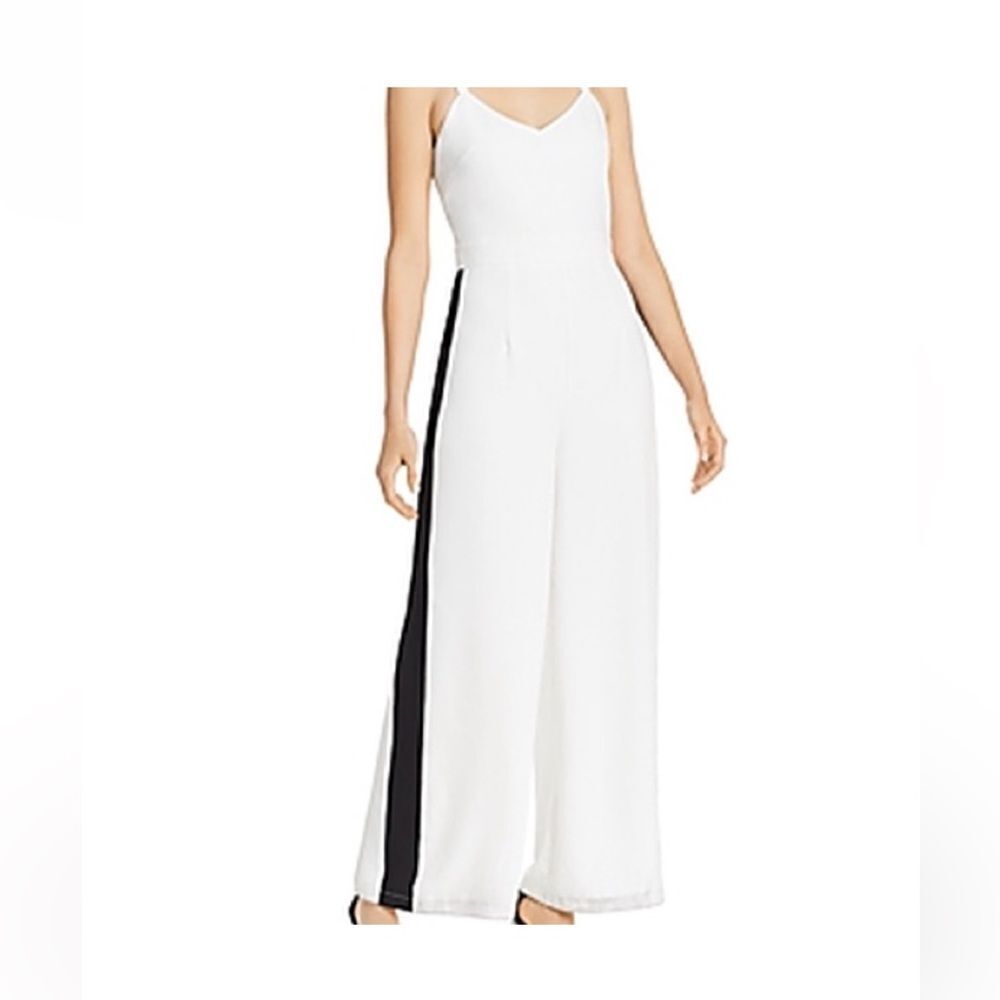 Aqua brand white flare leg jumpsuit with black stripes on both sides